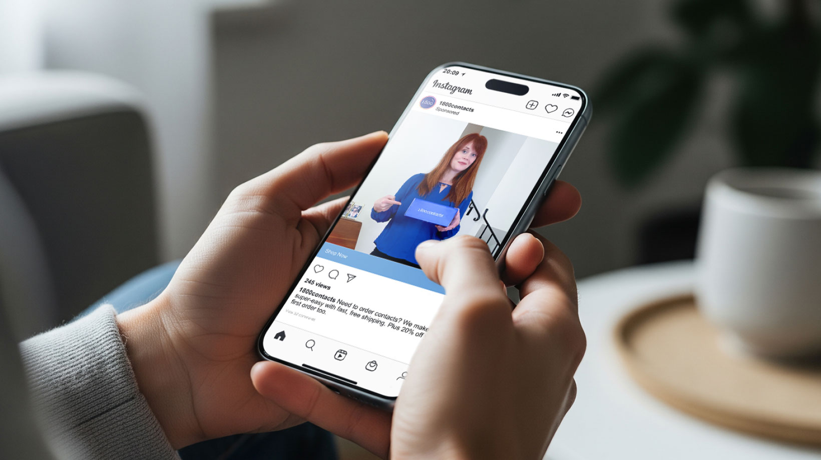 Two hands holding a mobile phone with a 1-800-Contacts ad